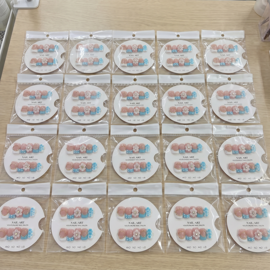 Full set of sky blue polka dot 3D floral square press on nails displayed on size cards.