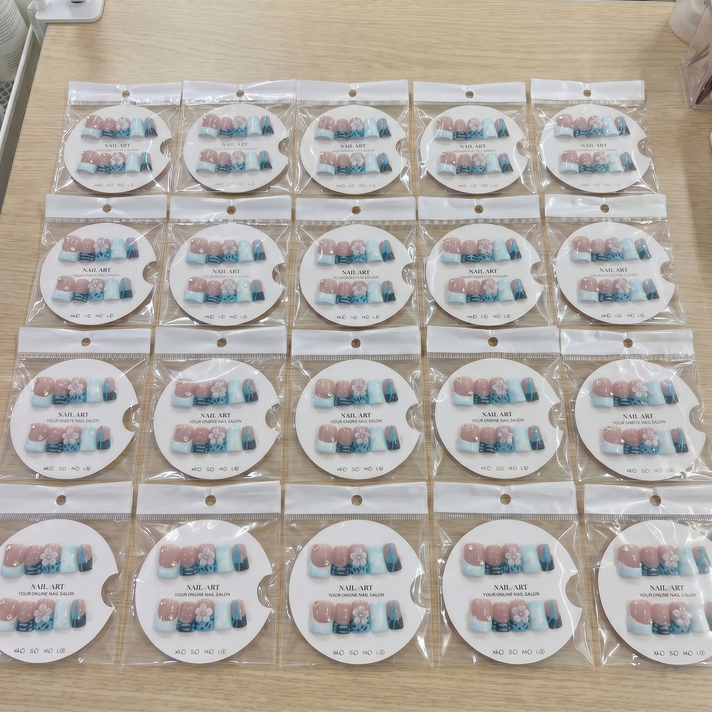 Full set of blue abstract 3D flower square press on nails displayed on size cards for custom fit.