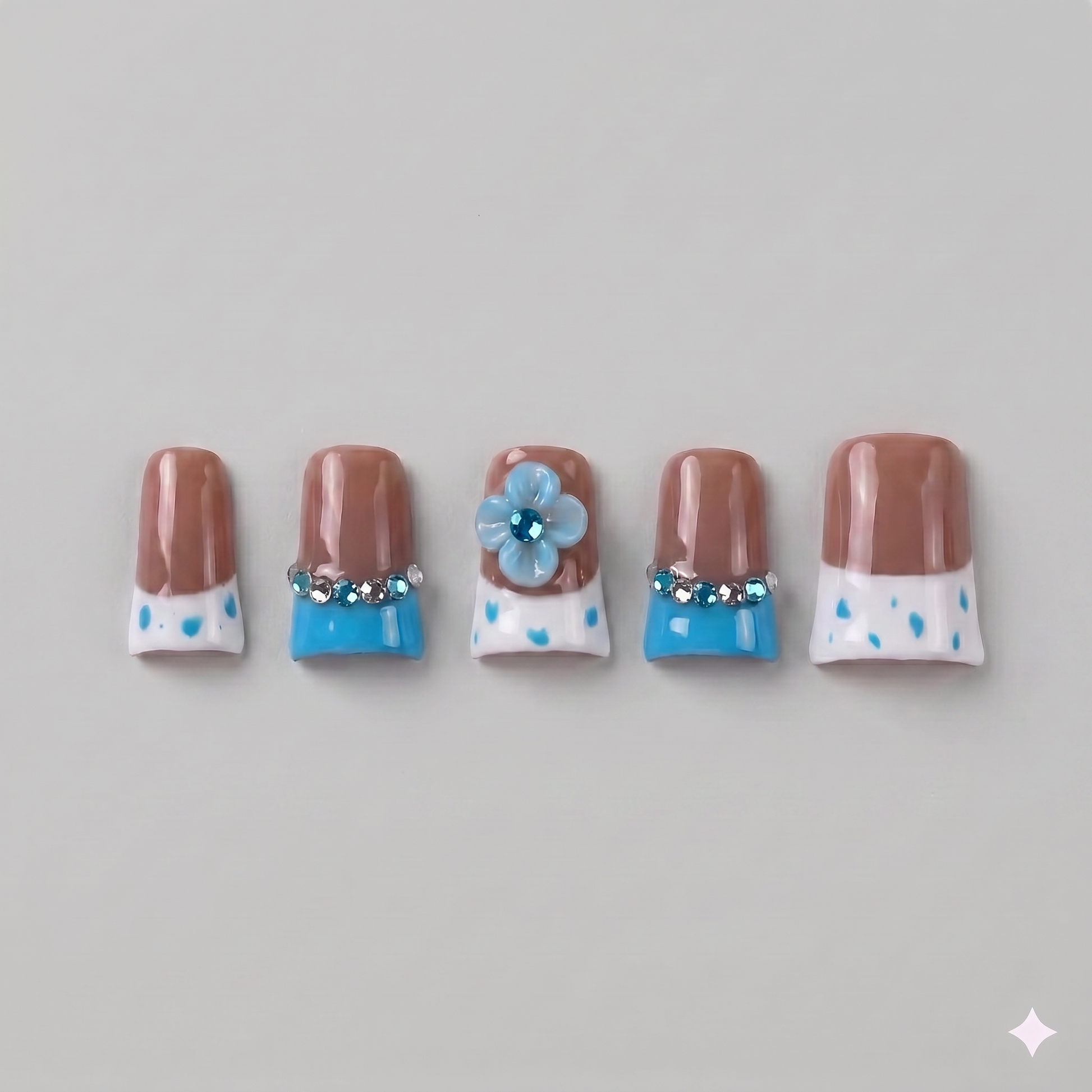 Brown and blue polka dot square press on nails featuring a 3D blue blooming flower, a ribbon bow, and vibrant French tips.