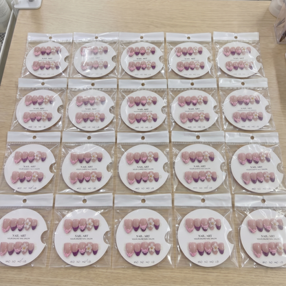 Full set of burgundy French tip 3D floral almond press on nails displayed on size cards.