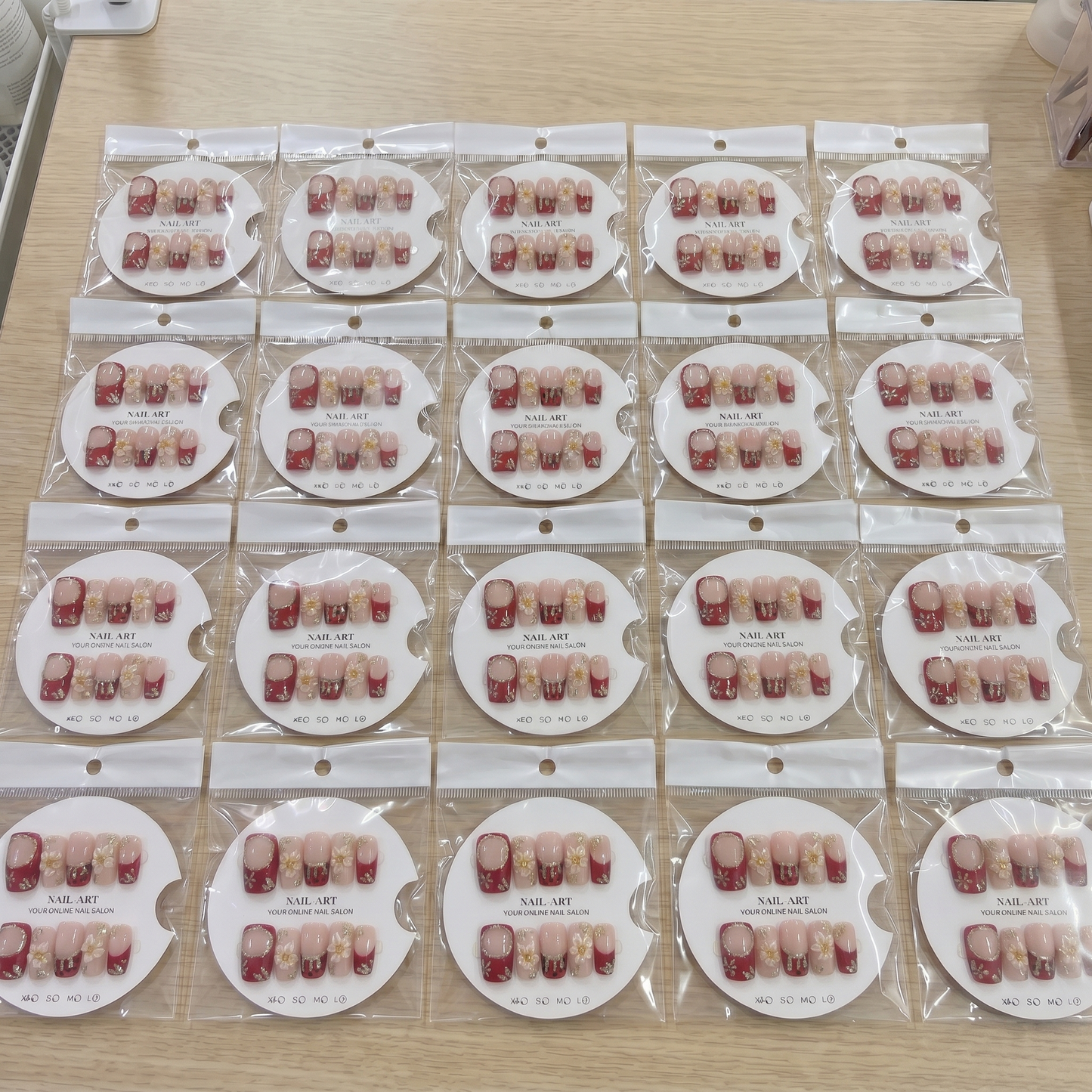 Full set of deep red French tip 3D floral square press on nails displayed on size cards.