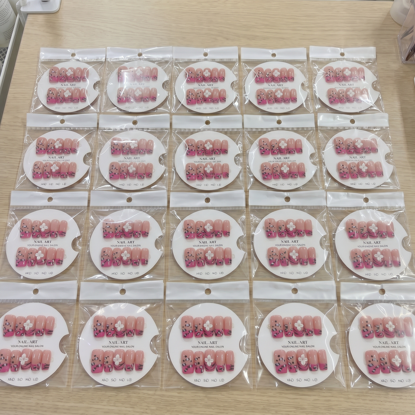 Full set of hot pink cheetah 3D floral square press on nails displayed on size cards.