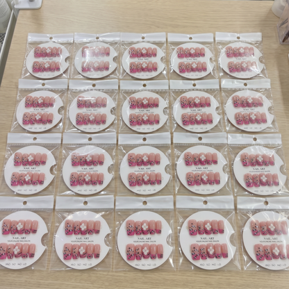 Full set of hot pink cheetah 3D floral square press on nails displayed on size cards.
