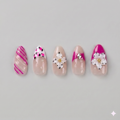 Hot pink floral almond press on nails featuring eye-catching French tips, playful swirls, and delicate white daisies with pearl centers.