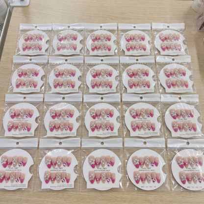 Full set of hot pink leopard 3D floral almond press on nails displayed on size cards.