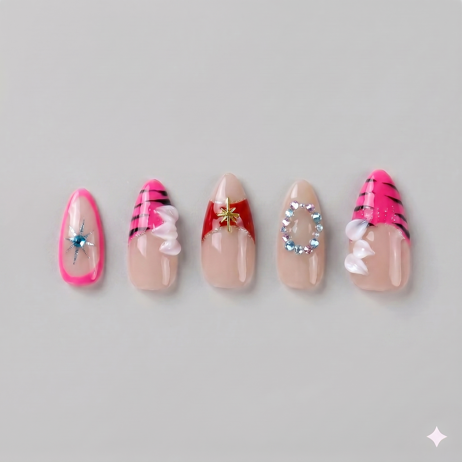 Mix and match hot pink almond press on nails featuring edgy zebra prints, silver 3D gems, sparkling rhinestone chains, and abstract lines.