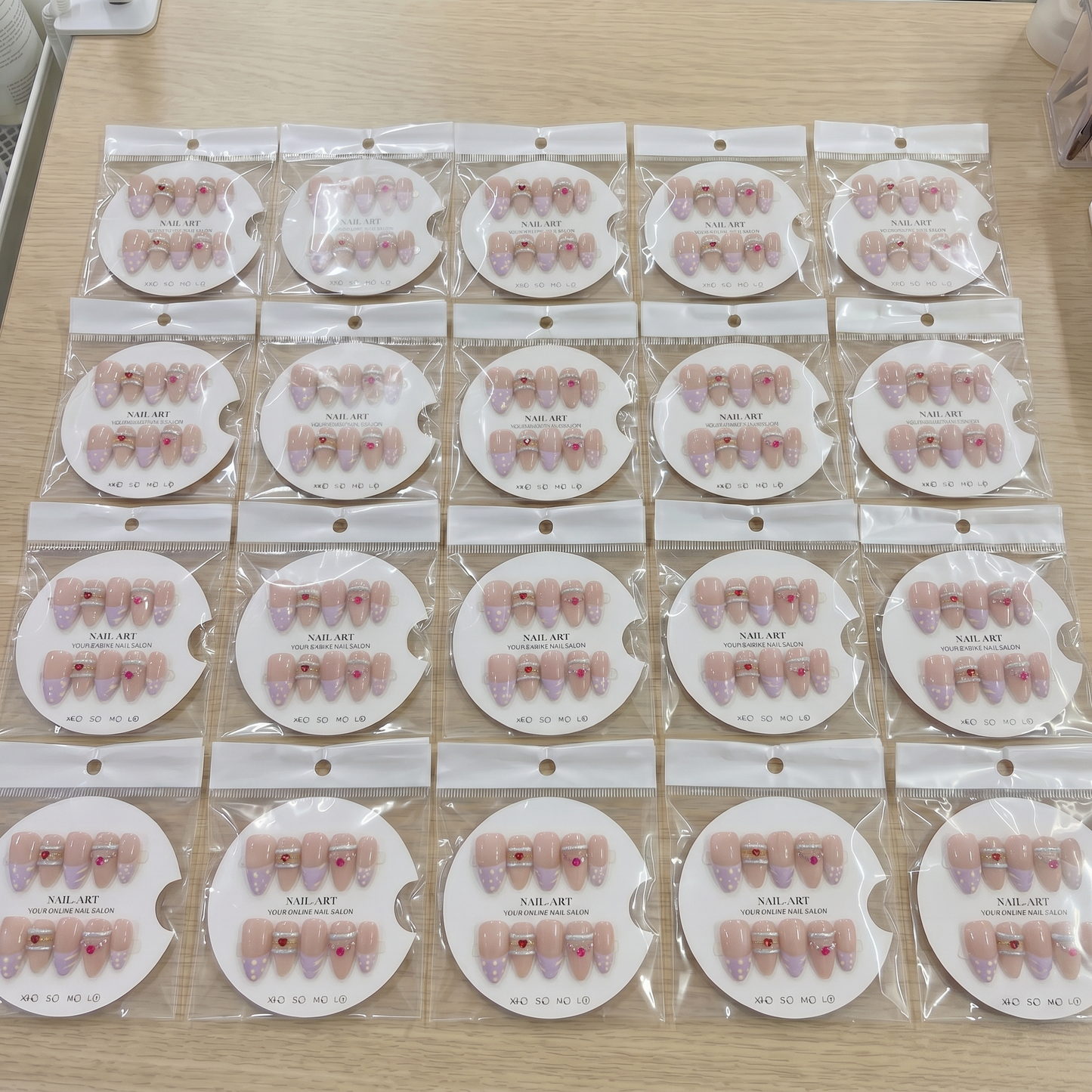 Full set of lavender gold swirl almond press on nails displayed on size cards.