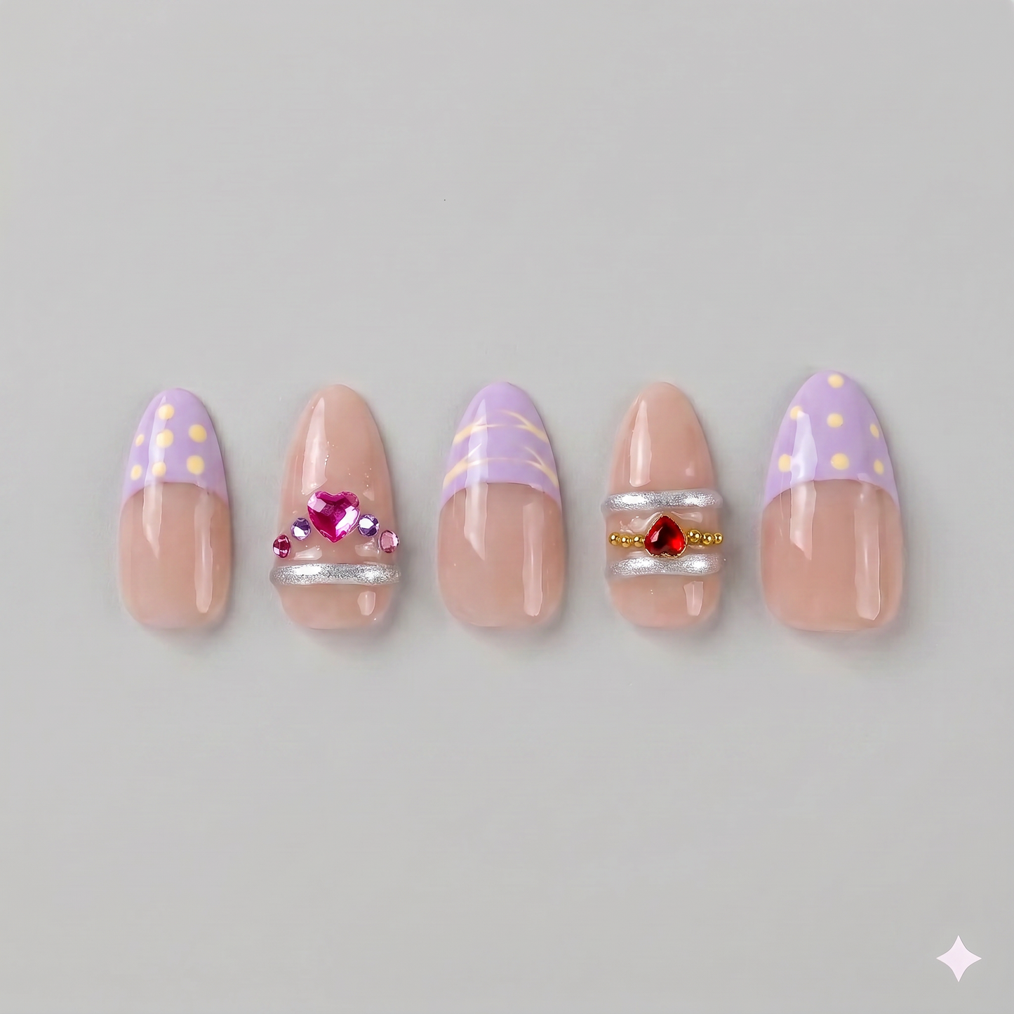Lavender gold swirl almond press on nails featuring soft French tips, elegant gold chrome swirls, and sparkling pink and red rhinestones.