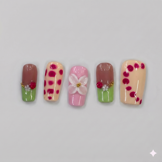 Matcha green square press on nails featuring French tips, playful red wavy borders, a 3D pink ribbon bow, and a delicate blooming flower.