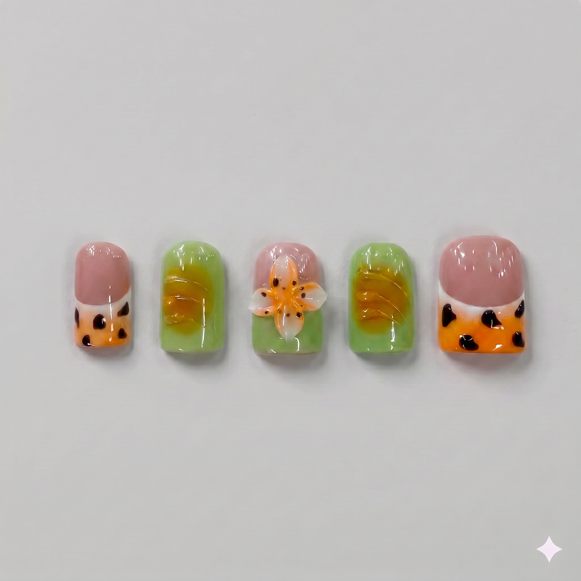 Mix and match olive green and orange leopard print square press on nails featuring a 3D orange blooming flower and wavy French tips.