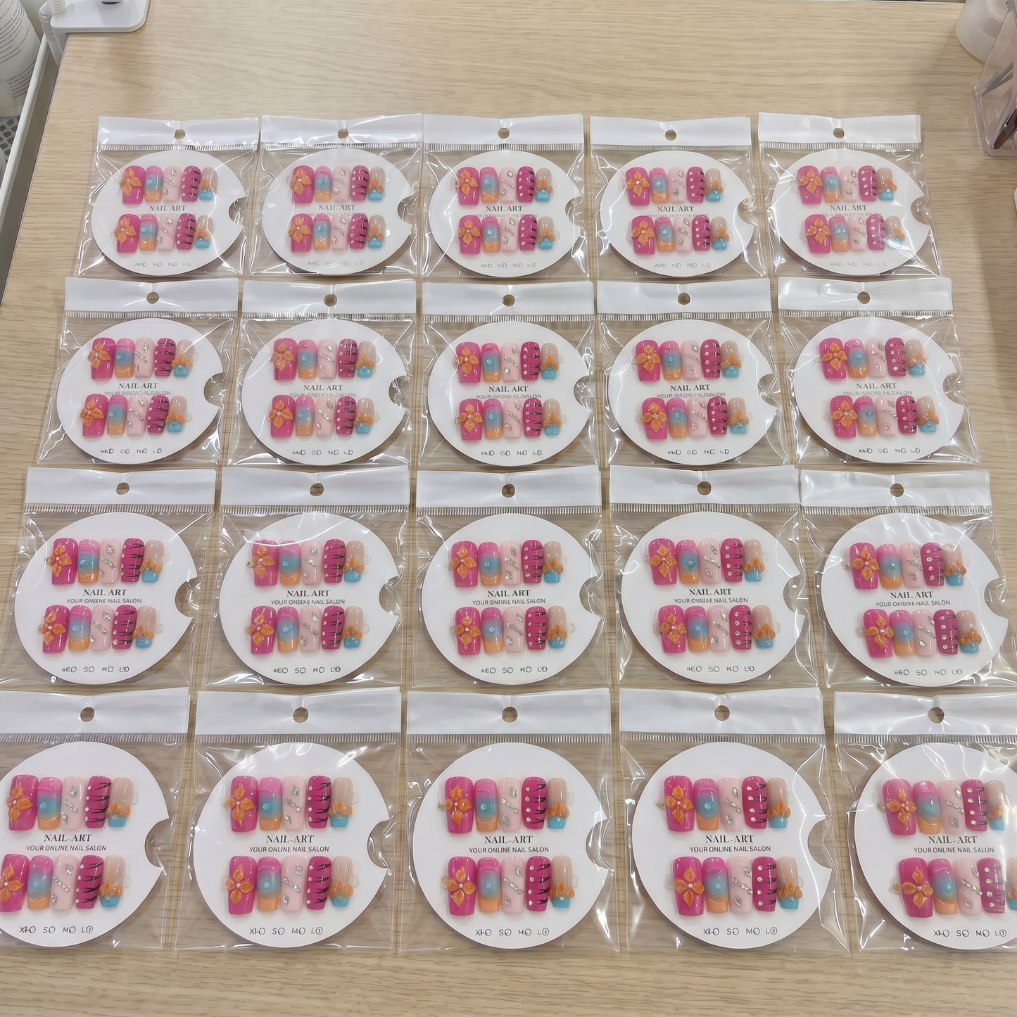Full set of orange and pink 3D floral square press on nails displayed on size cards.