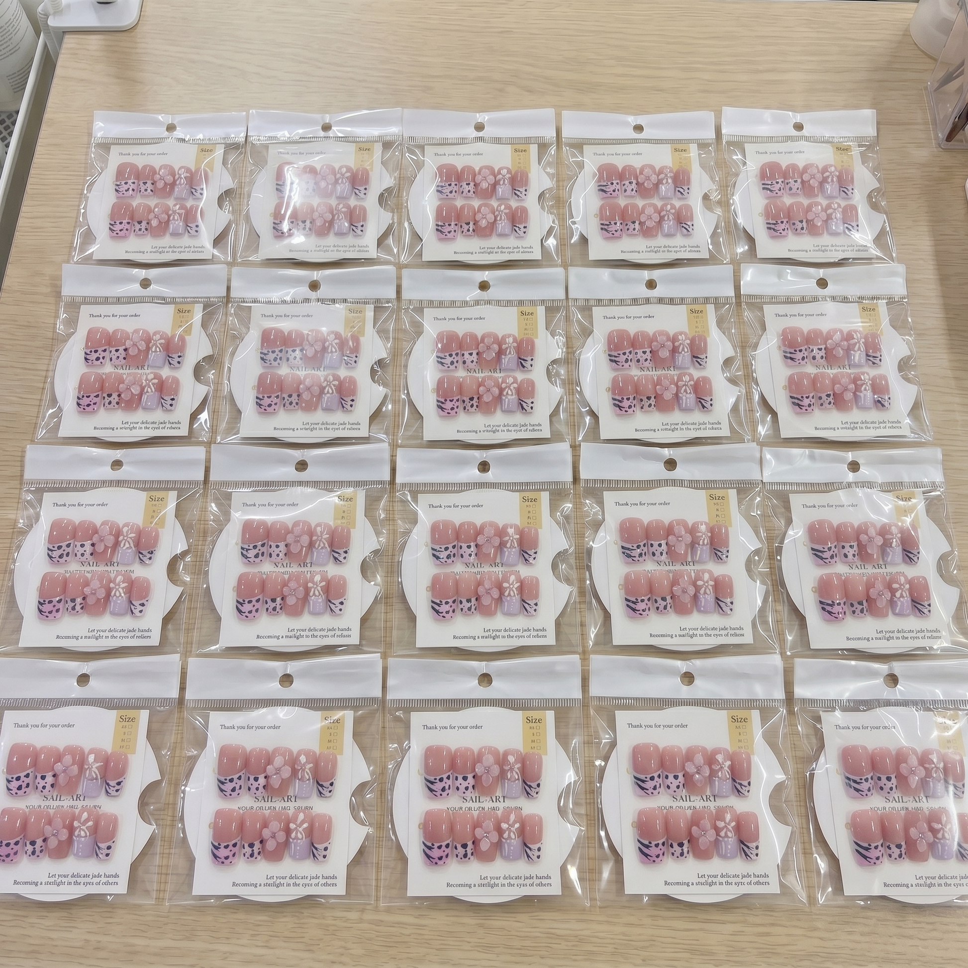Full set of pink animal print 3D floral square press on nails displayed on size cards.