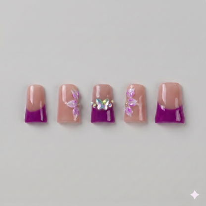 Plum purple French tip square press on nails featuring a dazzling rhinestone accent nail and delicate white starbursts.