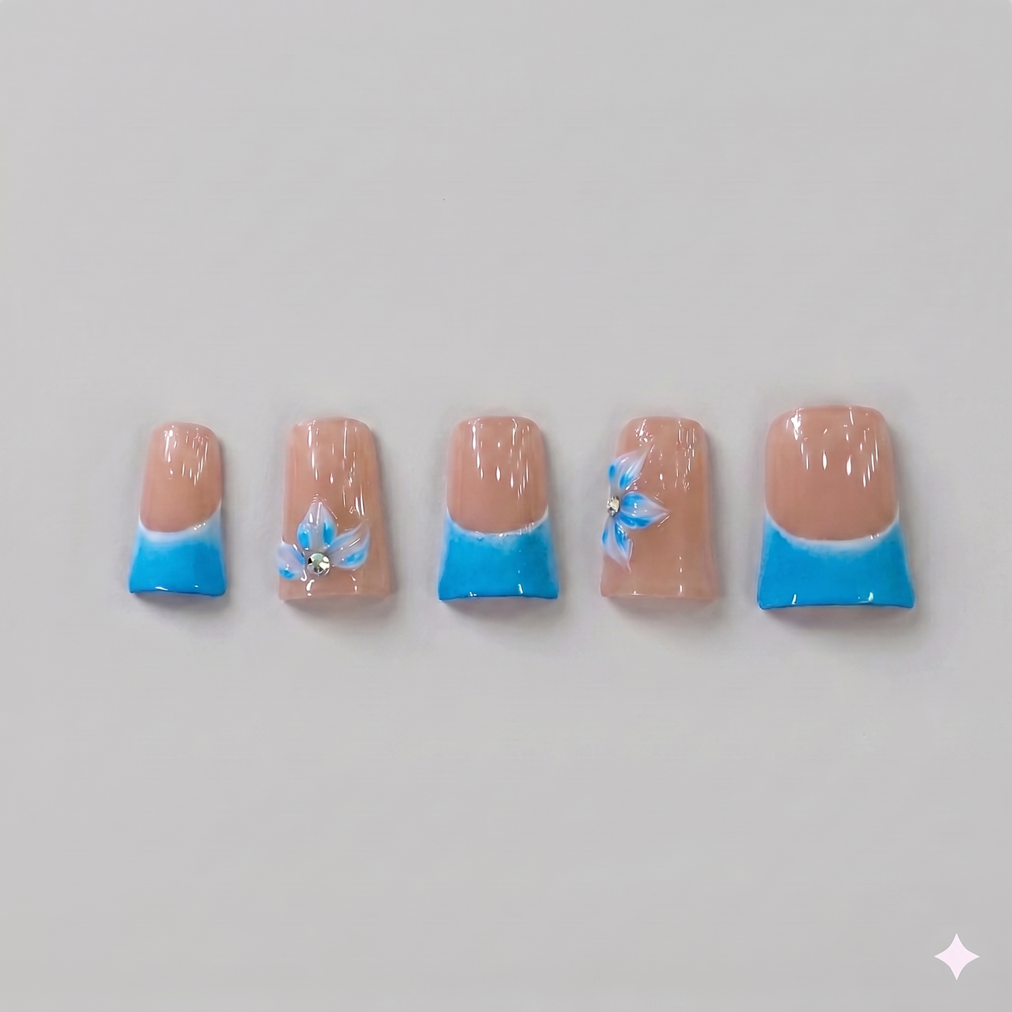 Sky blue French tip square press on nails featuring delicate 3D blue ribbon bows, white blooming flowers, and subtle sparkling rhinestones.
