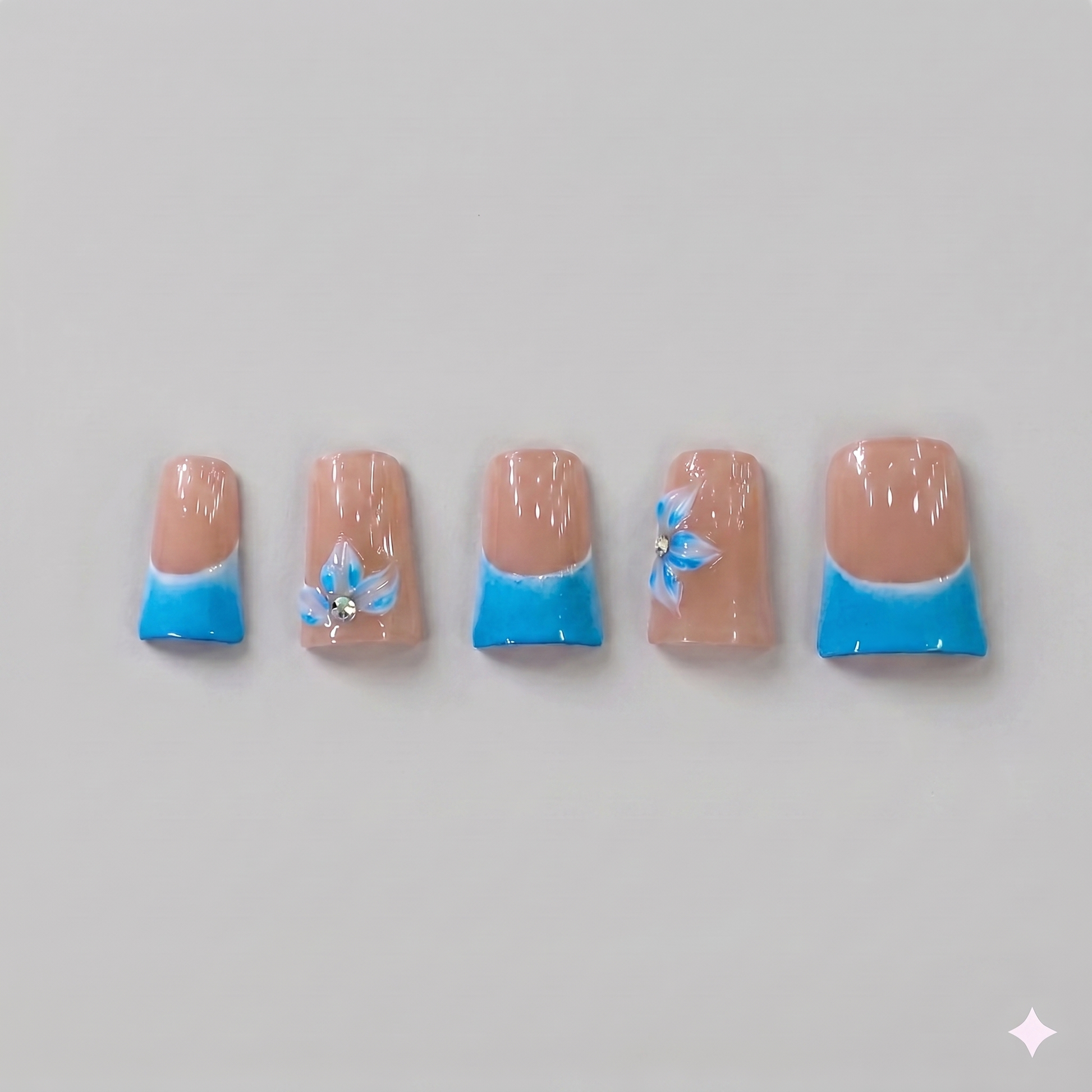 Sky blue French tip square press on nails featuring delicate 3D blue ribbon bows, white blooming flowers, and subtle sparkling rhinestones.