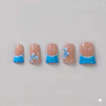 Sky blue French tip square press on nails featuring delicate 3D blue ribbon bows, white blooming flowers, and subtle sparkling rhinestones.