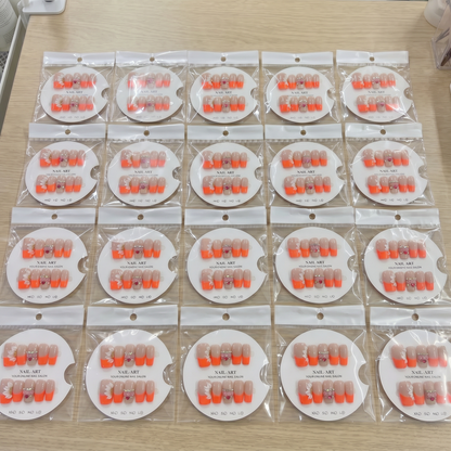 Full set of vibrant orange French tip 3D floral square press on nails displayed on size cards.