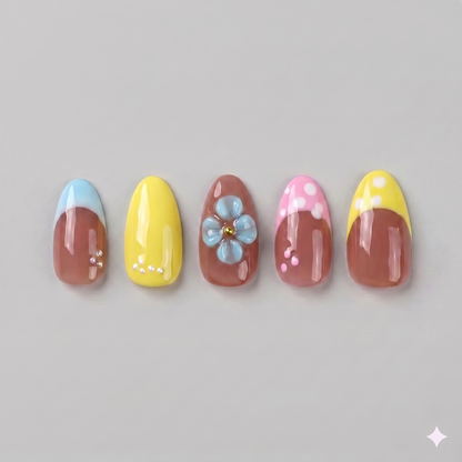 Retro yellow French tip almond press on nails featuring delicate white polka dots and a statement 3D baby blue blooming flower.