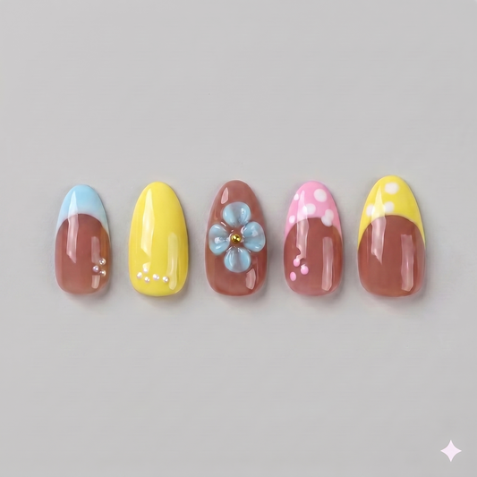Retro yellow French tip almond press on nails featuring delicate white polka dots and a statement 3D baby blue blooming flower.